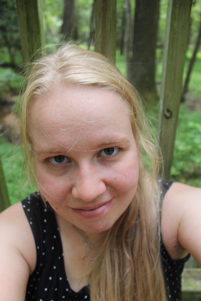 A picture of the blog author sitting outside on a bridge