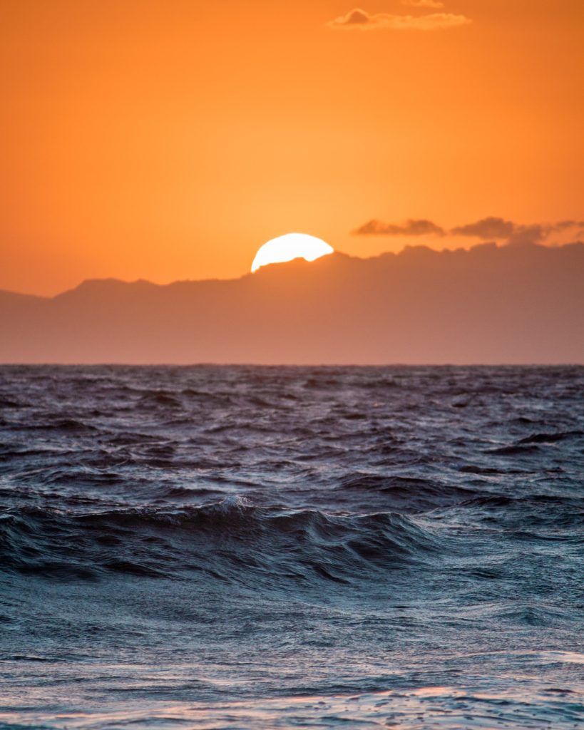 The sun rises over a vast ocean landscape showing us the beauty of nature